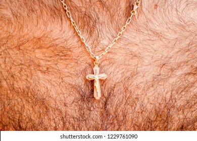 Golden Cross With A Chain On A Hairy Chest