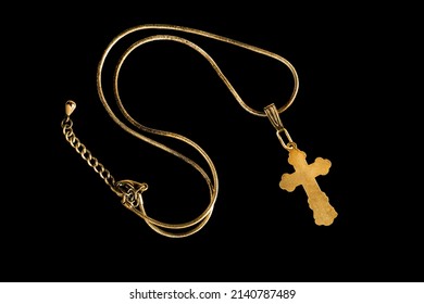 Golden Cross Necklace Isolated On Black Background