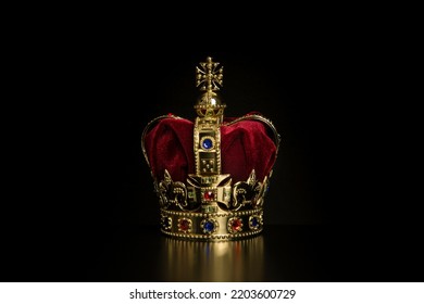 Golden crown on a black background with copy space - Shutterstock ID 2203600729