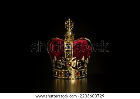 Golden crown on a black background with copy space
