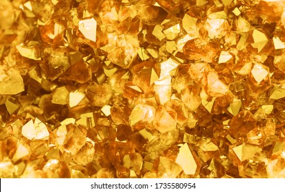Golden crystal mineral stone. Gems. Mineral crystals in the natural environment. Texture of precious and semiprecious stones. Seamless background with copy space.