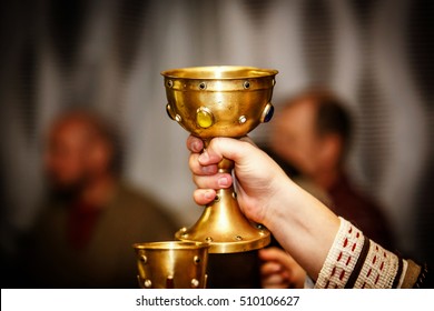 Golden Cup In Hand On A Medieval Feast