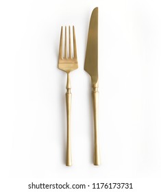 Golden cutlery view from above on a white background. Top view.
Knife and fork for a festive table for a wedding, birthday or party.
