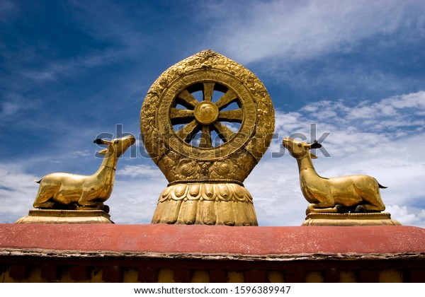 A golden dharma wheel\
and deer adorn the roof of the Jokhang Temple, Barkhor Square,\
Lhasa, Tibet, China