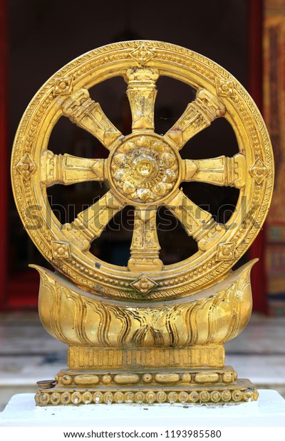 Golden Dharma Wheel on\
stand