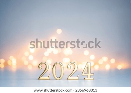 Golden digits in 2024 number with bokeh lights in the background. 2024 new year backdrop. Light and soft