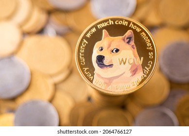 The golden Dogecoin with background of regular coins. Dogecoin cryptocurrency symbol - Shutterstock ID 2064766127