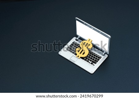 Golden dollar sign gracefully rests on an open miniature laptop, embodying the concept of potential financial opportunities, online earning and internet income.