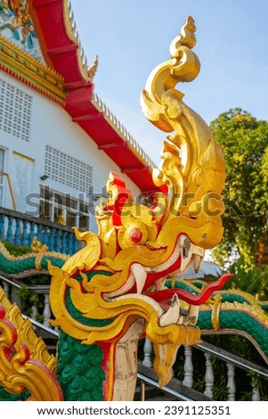 Golden dragon in the Buddhist white temple Wat Sawang Arom in Thailand.