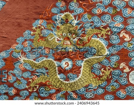Golden dragon, surrounded by the auspicious cloud, on the red 