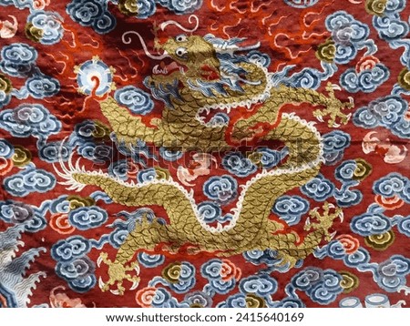 Golden dragon, surrounded by the auspicious cloud, on the red 