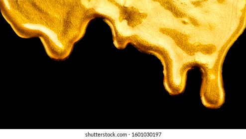 Golden dripping liquid paint texture, isolated on black background. Flowing abstract Gold metallic paint drops close-up. Leaking Lipgloss, blots of nail polish. Border art design   