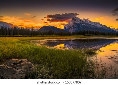 Golden early fall sunrise over the Canadian Rockies and Vermilion Lakes on the outskirts of Banff, Canada - Shutterstock ID 158577809