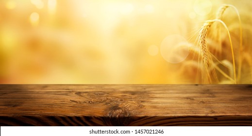 Golden Ears Of Wheat With Rustic Wooden Table For A Thanksgiving Decoration