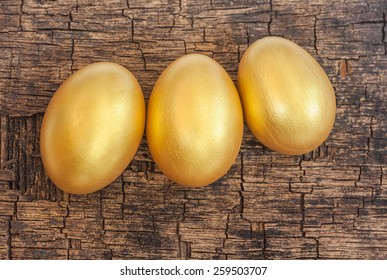 Golden Easter Egg On Old Crack Wooden Board