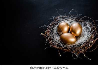 Golden Easter Eggs in birds Nest on black background. Easter Holiday concept abstract background copyspace top view several objects. - Powered by Shutterstock