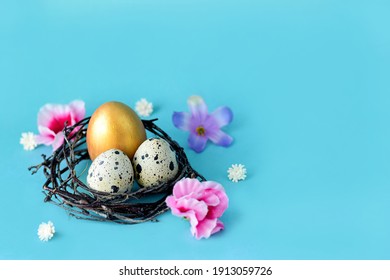 Golden Easter eggs in a nest on a blue background with space. Easter decoration, colored eggs in a bird nest with flowers.  Turquoise pastel background.  - Powered by Shutterstock