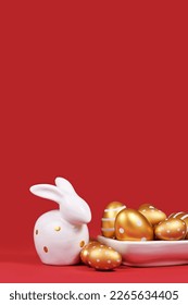 Golden Easter eggs painted with stripes and dots and bunny on red background with copy space