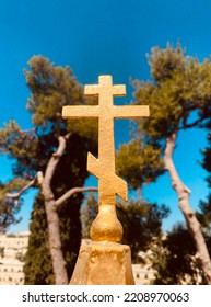 Golden Eastern Orthodox Cross On Blue Sky Background