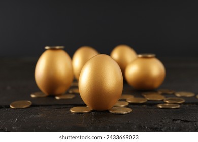 Golden eggs with coins on a dark background - Powered by Shutterstock