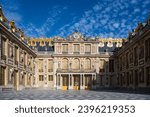 Golden entry gates of Chateau De Versailles with setting sunlight, France - 27 Jul 2022