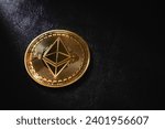 Golden Ethereum is an asset of choice for many investors, close up Golden Ethereum ETH coin , Ethereum ocin crypto currency on black leather and bright light background.