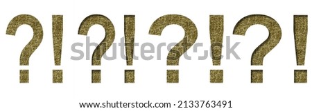 Golden exclamation and question marks cut out of white paper on the backdrop of a pattern of gold threads, decorative font.