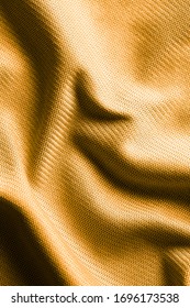 Golden fabric as an abstract background. Texture