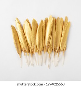 Golden Feather On A White Background