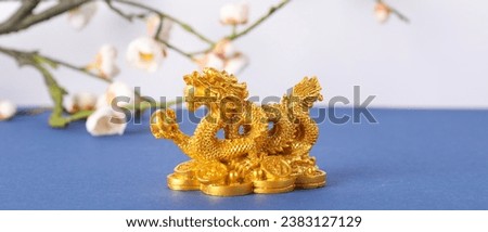 Golden figurine of Chinese dragon on table