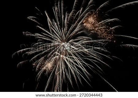 Golden Fireworks Burst Exploding in Night Sky with Sparkling Light Trails and Glowing Particles. Spectacular Pyrotechnic Display for New Year Celebration Festival Event Background