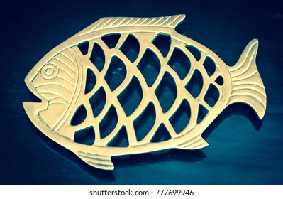 Golden fish. Element of wooden shelf. Vintage object against blue background. - Powered by Shutterstock