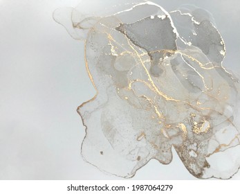 Golden fluid art marble ink texture on white background. Abstract glitter luxury art.