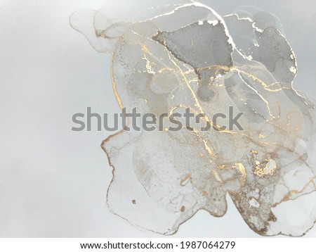 Golden fluid art marble ink texture on white background. Abstract glitter luxury art.