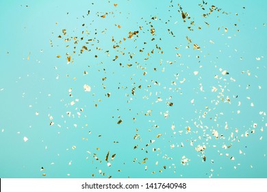 Golden flying sparkles on blue holiday background. Festive backdrop for your projects. - Shutterstock ID 1417640948