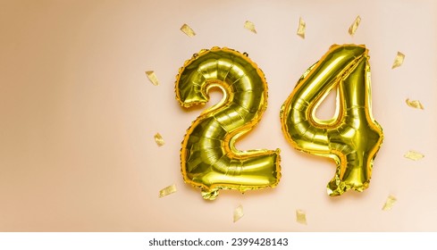 A golden foil balloon with the number twenty-four. A birthday or anniversary card with the inscription 24. the color is peach fuzz . Anniversary celebration. The banner. copy space