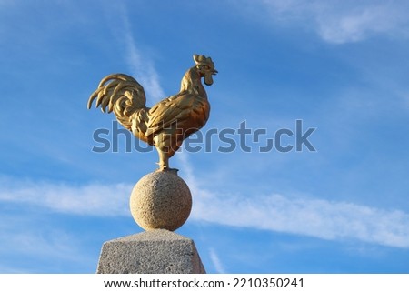 Golden Gallic Rooster, National French Emblem, Against a Bright Blue Sky.