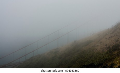 Golden Gate Bridge concealed by the fog on a summer morning, viewed from Battery Spencer, a Fort Baker site 
  - Powered by Shutterstock