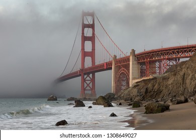 The Golden Gate Bridge in downtown San Fransisco covered in fog, as seen from Marshall's Beach.  - Powered by Shutterstock