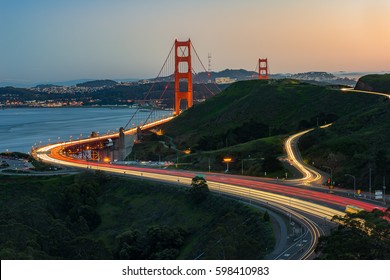 Golden Gate Bridge And Light Trail Of Highway 1 During Sunset