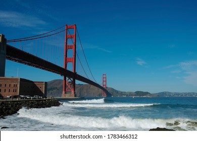 Golden Gate Bridge, San Francisco, California USA. Classic Panoramic View, Famous Landmark. Touristic Attraction, Travel Destination At Sunny Surf Beach Day, Of Blue Clear Sky. Surfing Next Fort Point