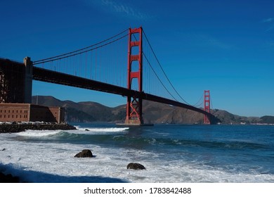 Golden Gate Bridge, San Francisco, California USA. Classic Panoramic View, Famous Landmark. Touristic Attraction, Travel Destination At Sunny Surf Beach Day, Of Blue Clear Sky. Surfing Next Fort Point