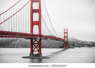 Golden Gate Bridge in San Francisco during foggy weather, a black and white photo with preserved red color. - Powered by Shutterstock