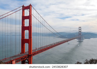 Golden Gate Bridge in San Francisco California. San Francisco skyline view through the suspension cables of Golden Gate Bridge on a foggy day. Downtown view bay cloud car. Red Golden Gate - Powered by Shutterstock