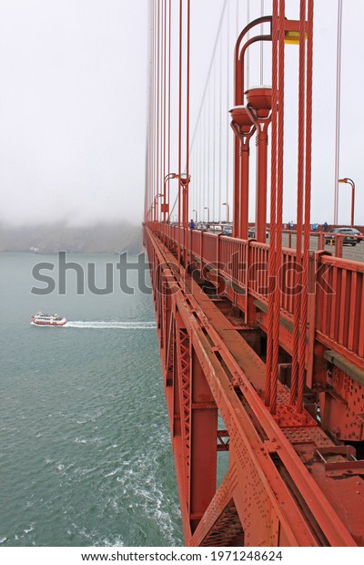 Golden Gate Bridge, San\
Francisco, USA - an engineering masterpiece, art deco steel\
construction in orange with details such as lighting, outlining the\
cables and towers 