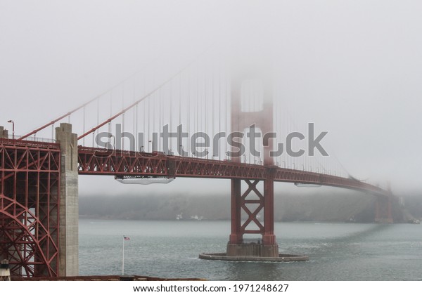 Golden Gate Bridge, San Francisco, USA-engineering
masterpiece, art deco steel construction in orange with details
such as lighting, outlining the cables and towers appearing out of
the vanishing fog