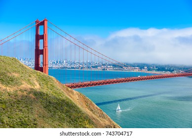 Golden Gate Bridge with the skyline of San Francisco in the background on a beautiful sunny day with blue sky and clouds in summer - Panoramic view from Battery Spencer - California, USA
