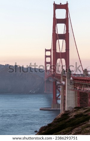 golden gate bridge at sunset, image shows the 2737 meter long bridge built in 1937 on a warm evening with clear skies showing a array of sunset colours, taken october 2023