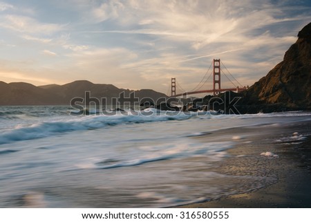 The Golden Gate Bridge at sunset, seen from Baker Beach, San Francisco, California.