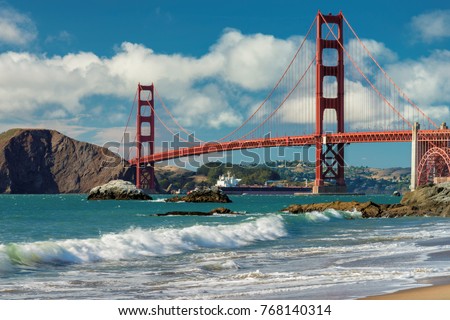 Golden Gate Bridge at sunset seen from San Francisco beach, California.